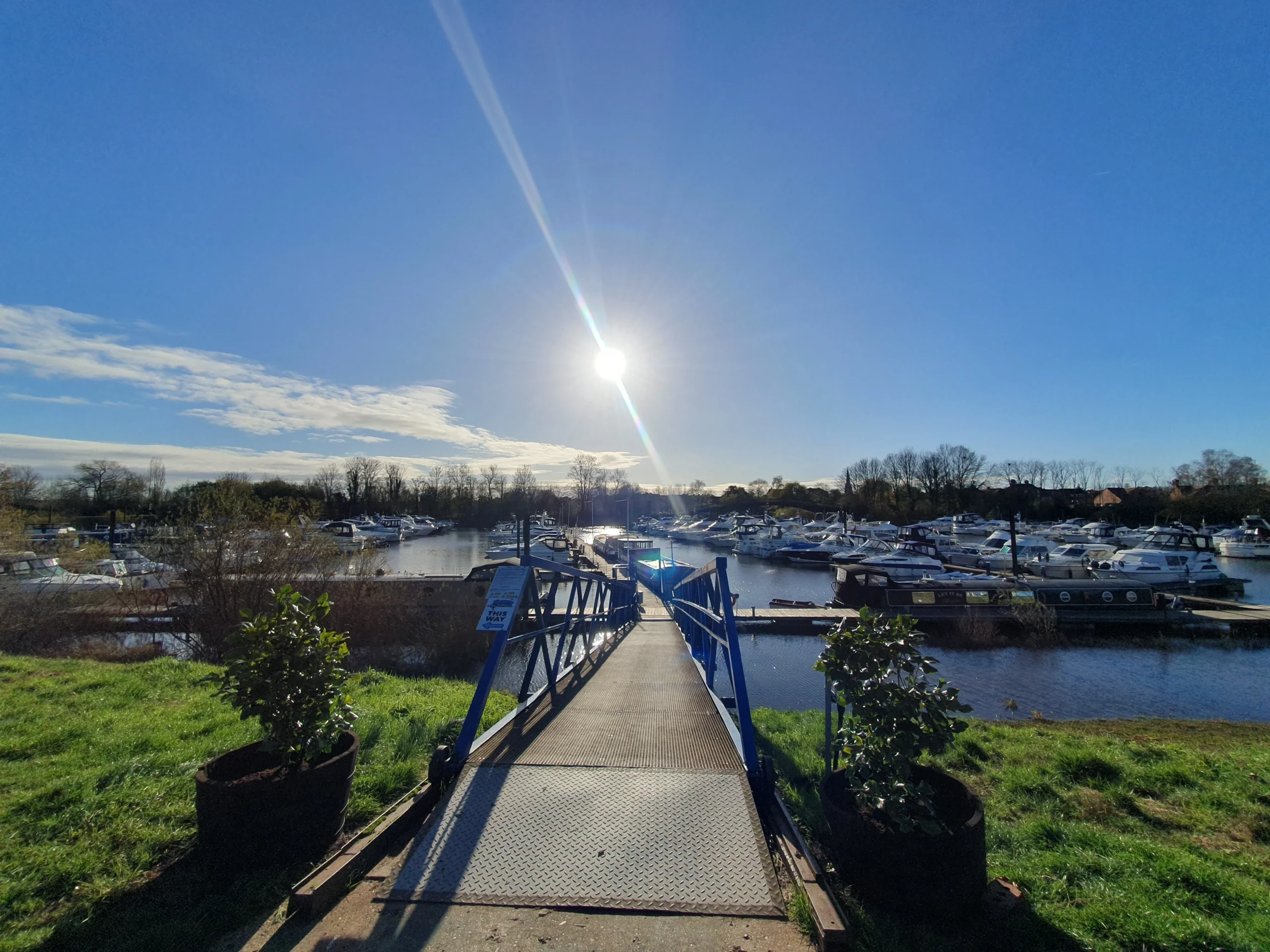 Upton Upon Severn 9 the beginning of jetty of which there are many of parked boats, with the sun in its highest postion.