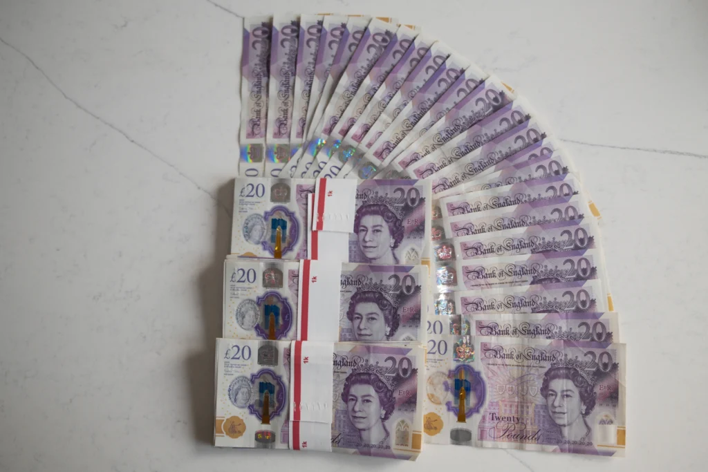 Is HGV Driving For You? 3 Stack of cash on a table to represent money and earnings.