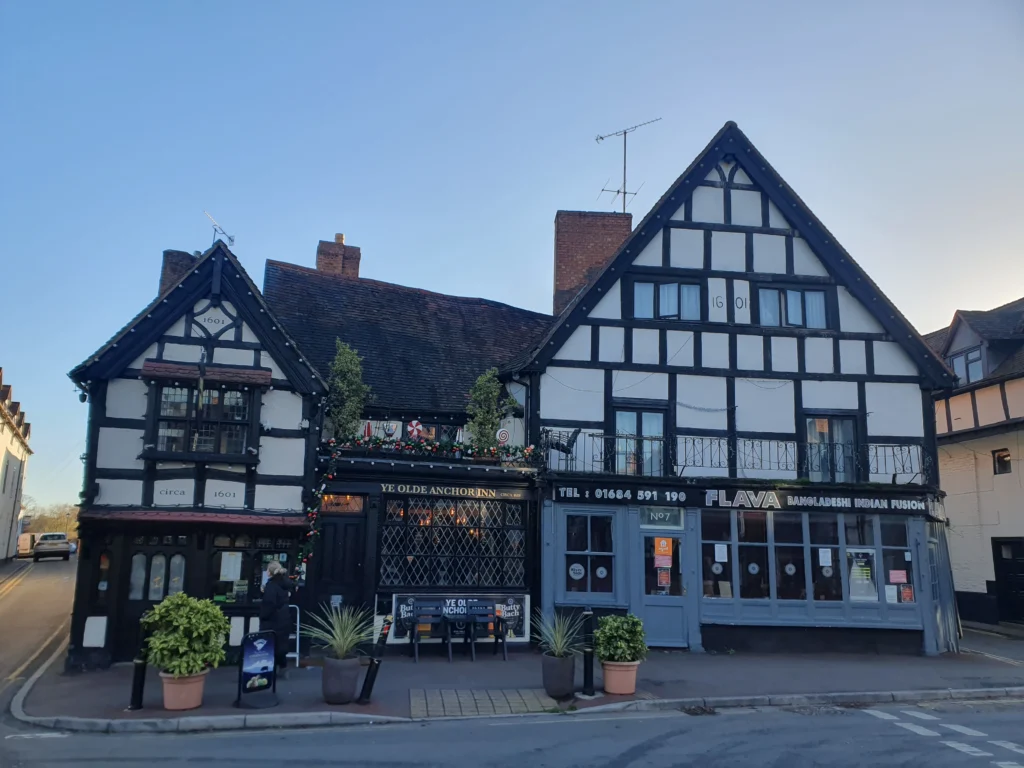 Upton Upon Severn 5 A victorian tutor looking building, getting setup up for Christmas lights built in 1601 - it contains a pub and food restaurant.